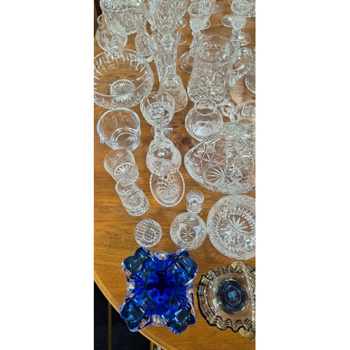 552 - A Large collection of crystal and glass ware; Decanters, candlesticks, vases and drinking glasses