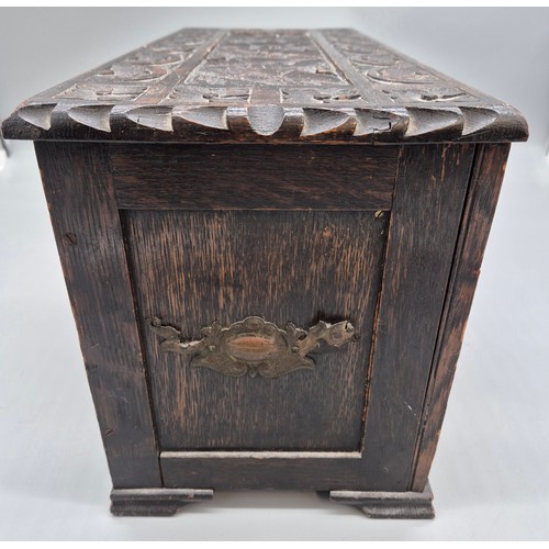 240A - Antique hand carved oak smokers chest together with a small vintage travel iron.