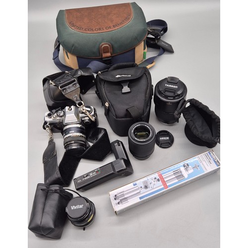 261 - A collection of camera lenses & Olympus OM 10 model camera; Nikkor DX lens, Tamron camera lens & oth... 