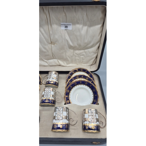 39 - Boxed Aynsley coffee can and saucers set fitted with Sheffield silver cup inserts. Comes within a pr... 