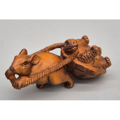 31 - Japanese hand carved boxwood netsuke in the form of a mouse pulling a turtle. Signed. [6cm length]