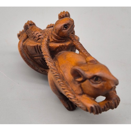 31 - Japanese hand carved boxwood netsuke in the form of a mouse pulling a turtle. Signed. [6cm length]