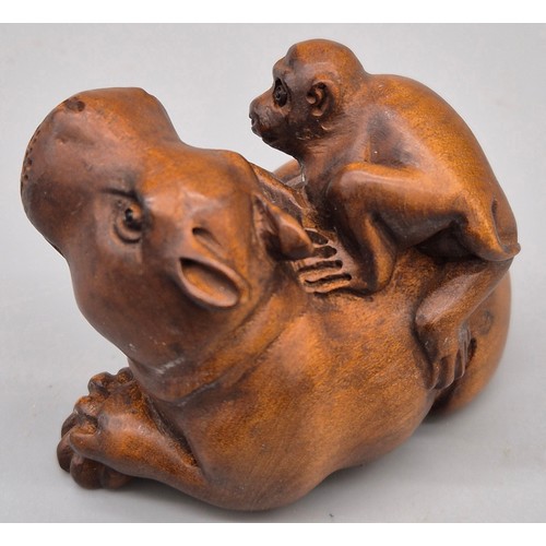 36 - Japanese hand carved boxwood netsuke in the form of a monkey sat upon a hippos back. Signed. [5cm le... 