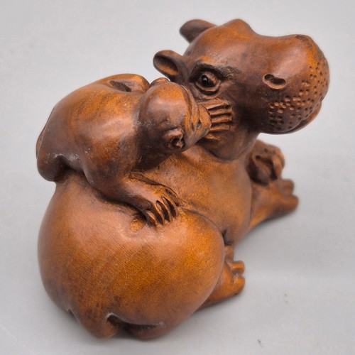 36 - Japanese hand carved boxwood netsuke in the form of a monkey sat upon a hippos back. Signed. [5cm le... 