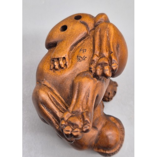 36 - Japanese hand carved boxwood netsuke in the form of a monkey sat upon a hippos back. Signed. [5cm le... 