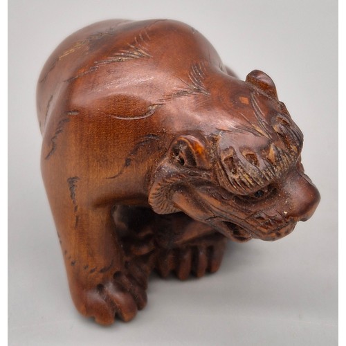 16 - Japanese hand carved boxwood netsuke in the form of a seated tiger. Signed and fitted with black bea... 