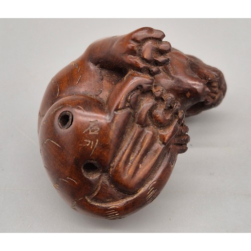 16 - Japanese hand carved boxwood netsuke in the form of a seated tiger. Signed and fitted with black bea... 