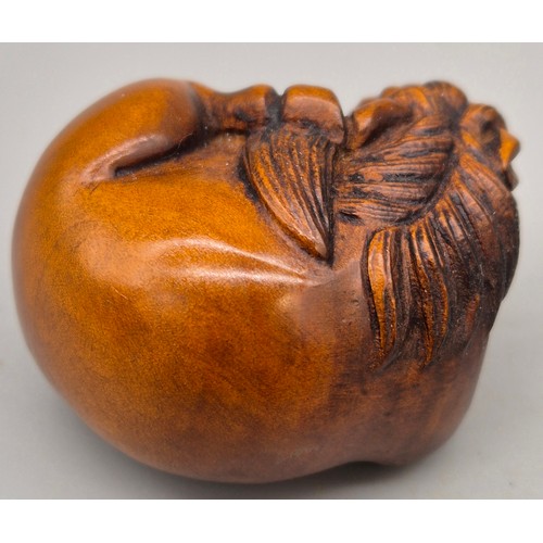 46 - Japanese hand carved boxwood netsuke in the form of a horse laying down. Signed. [4cm length]