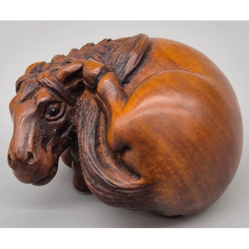 46 - Japanese hand carved boxwood netsuke in the form of a horse laying down. Signed. [4cm length]