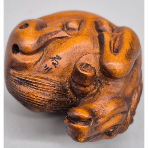 46 - Japanese hand carved boxwood netsuke in the form of a horse laying down. Signed. [4cm length]