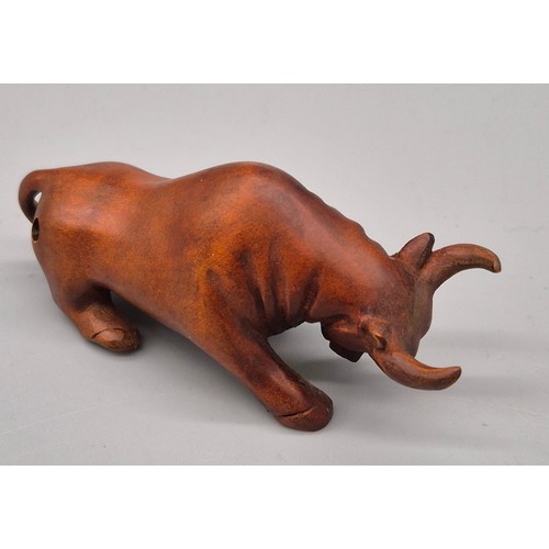 26 - Japanese hand carved boxwood netsuke in the form of a Bull. Signed. [7cm length]