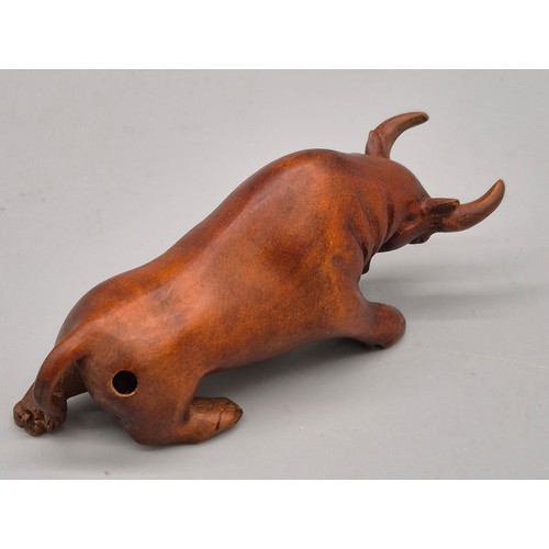 26 - Japanese hand carved boxwood netsuke in the form of a Bull. Signed. [7cm length]