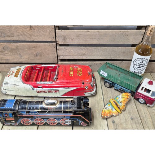 338 - Four tin plate model toys; Butterfly, Chief C.F.D. Large car model, Truck model and Japanese made T.... 