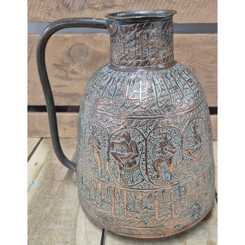 389 - Two antique Persian copper pourers/ jugs. Both worked with raised relief figures and panels. [Talles... 