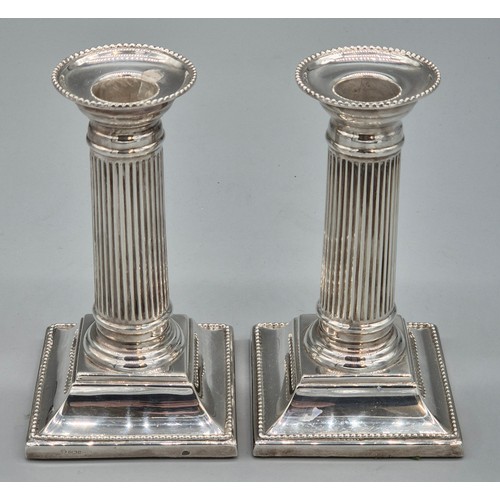 25 - A Pair of Sheffield silver hallmarked filled column candlesticks. Produced by C J Vander Ltd. [14.5c... 