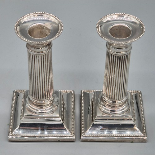 25 - A Pair of Sheffield silver hallmarked filled column candlesticks. Produced by C J Vander Ltd. [14.5c... 