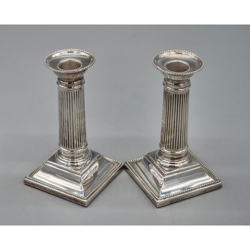 25 - A Pair of Sheffield silver hallmarked filled column candlesticks. Produced by C J Vander Ltd. [14.5c... 