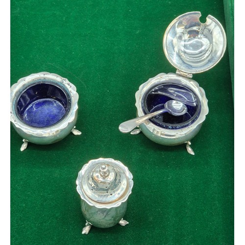 23 - Three piece Birmingham silver hallmarked condiment set. Two with blue liners and plated condiment sp... 