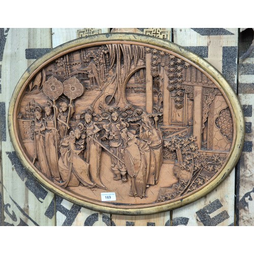 169 - Antique Chinese hand carved wall panel. Oval form and depicting group scene. Finished with a gilt fr... 