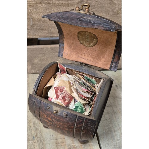 257 - A Pair of heavy African bust book ends, antique barrel tea caddy containing vintage stamps together ... 