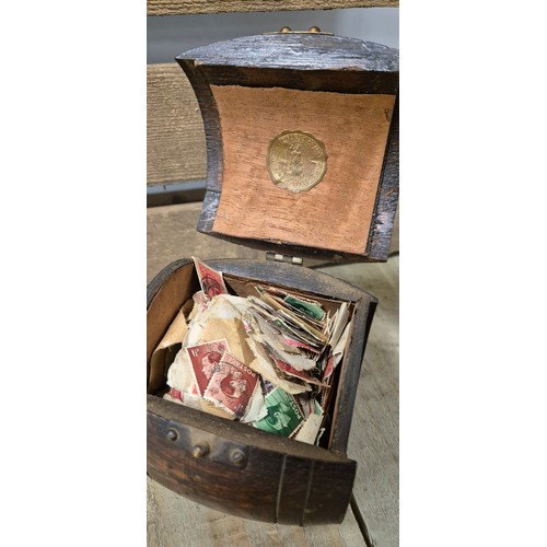 257 - A Pair of heavy African bust book ends, antique barrel tea caddy containing vintage stamps together ... 