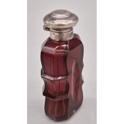 48 - Victorian Ruby facet cut and silver perfume bottle- Stopper present. [8cm high]