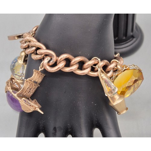 50A - Heavy antique 9ct rose gold charm bracelet fitted with various 9ct yellow gold charms. Includes one ... 