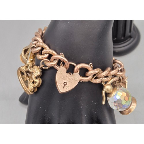 50A - Heavy antique 9ct rose gold charm bracelet fitted with various 9ct yellow gold charms. Includes one ... 