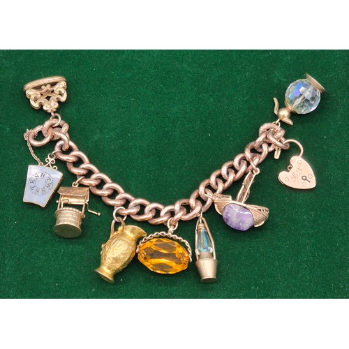 50A - Heavy antique 9ct rose gold charm bracelet fitted with various 9ct yellow gold charms. Includes one ... 