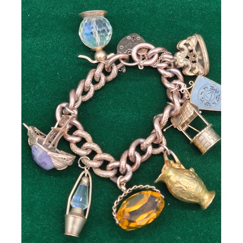 50A - Heavy antique 9ct rose gold charm bracelet fitted with various 9ct yellow gold charms. Includes one ... 