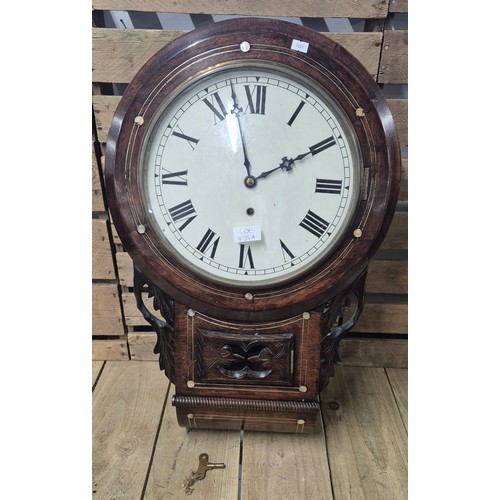 435A - A Late 19th century wall clock, comes with key and pendulum.