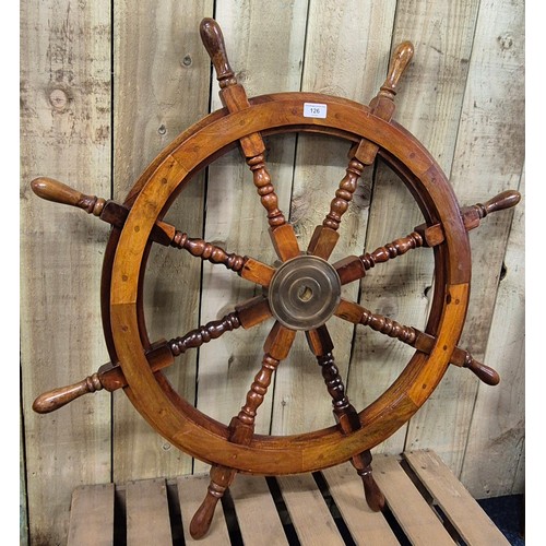 126 - Solid wood and varnished ships wheel. Brass centre. [91cm diameter]