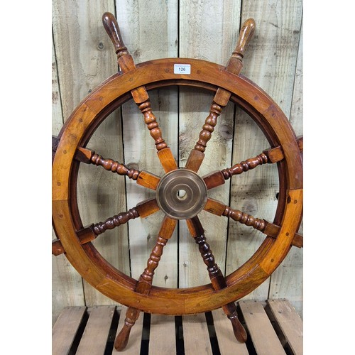 126 - Solid wood and varnished ships wheel. Brass centre. [91cm diameter]