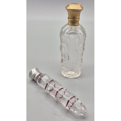 50 - Two antique perfume bottles; 19th century facet cut glass and gilt metal lidded scent bottle and one... 