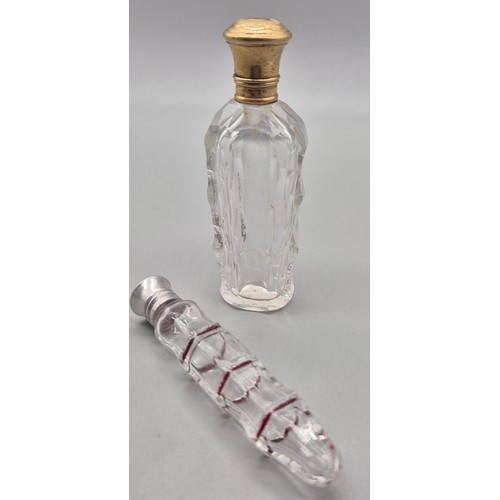 50 - Two antique perfume bottles; 19th century facet cut glass and gilt metal lidded scent bottle and one... 