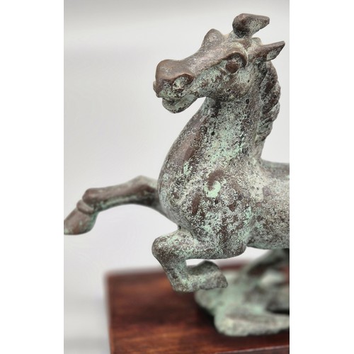 159 - Chinese bronze Tang horse raised upon a swallow bird. Comes with wooden stand. [17x18x8cm- includes ... 