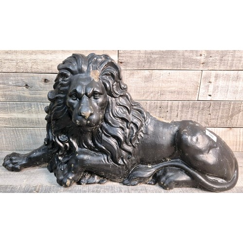 193 - 19th century cast metal resting lion door stop sculpture. [35x70x12cm]