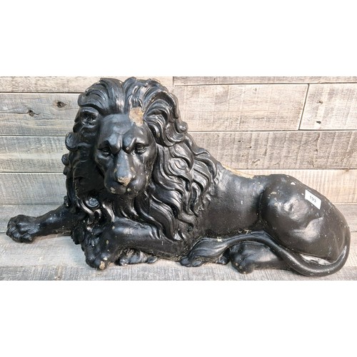 193 - 19th century cast metal resting lion door stop sculpture. [35x70x12cm]