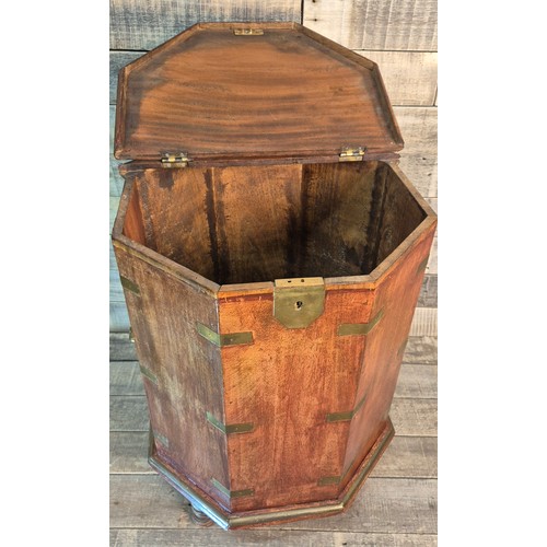 172 - Reproduction octagonal Mahogany and brass bound campaign table box. Brass handles to the sides. Rais... 