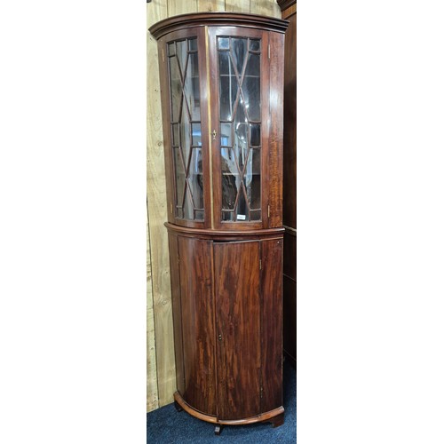 342 - 19th century Mahogany bow front corner cabinet. Top section having bow glass doors. brass trim and c... 