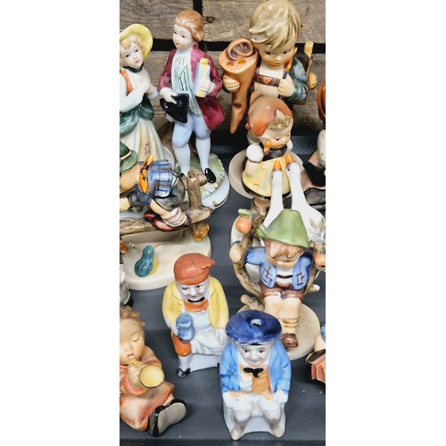 490 - A Tray of collectable German figurines; Hummel figures, German porcelain & others