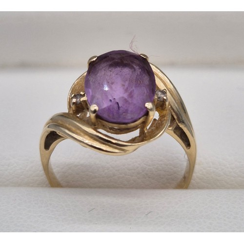 27 - 14ct yellow gold, Amethyst and diamond stone ring. Large oval cut amethyst and two small round cut d... 