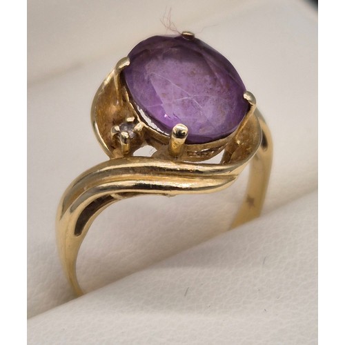 27 - 14ct yellow gold, Amethyst and diamond stone ring. Large oval cut amethyst and two small round cut d... 