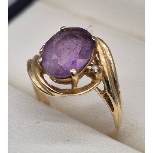 27 - 14ct yellow gold, Amethyst and diamond stone ring. Large oval cut amethyst and two small round cut d... 