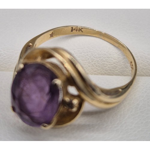 27 - 14ct yellow gold, Amethyst and diamond stone ring. Large oval cut amethyst and two small round cut d... 