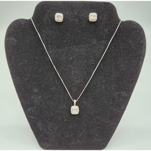 23 - 18ct white gold diamond cluster pendant [0.50ct] with a 9ct white gold chain. Together with a pair o... 