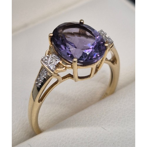 87 - 9ct yellow gold, Amethyst and diamond stone ring. Large oval cut amethyst, round cut diamonds. [Ring... 