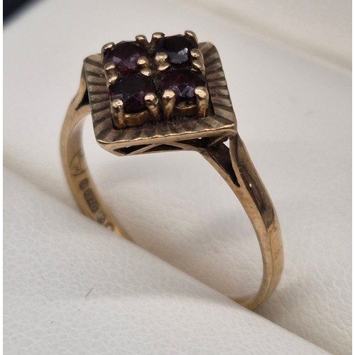 112 - 9ct yellow gold and Garnet stone ring. Four round cut garnets. [Ring size Q] [2.52Grams]