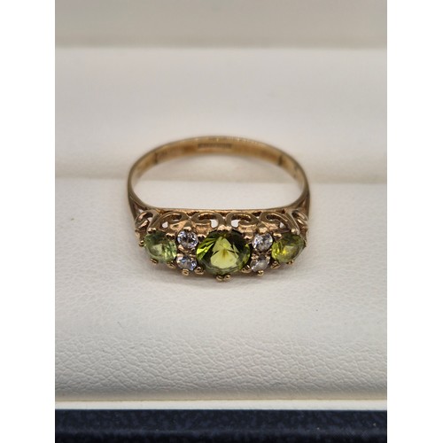 103 - 9ct yellow gold, Green Tourmaline and CZ gem stone ring. [Ring size N] [1.84Grams]