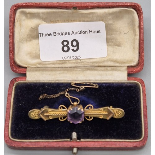 89 - 9ct yellow gold bar brooch fitted with a hexagonal cut Amethyst gem stone. [4grams]